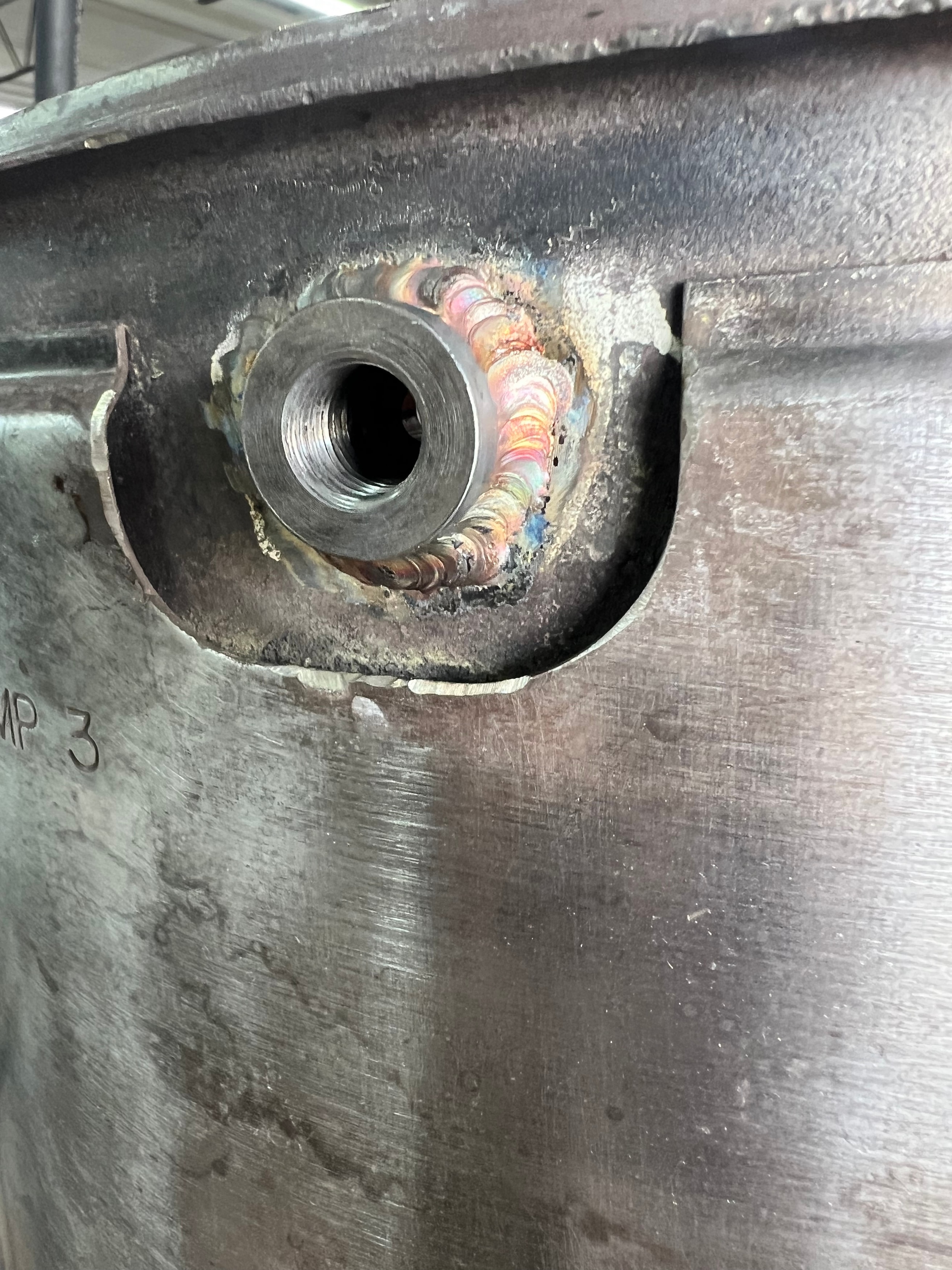 Damaged DPF sensor bung with stripped threads on diesel particulate filter housing