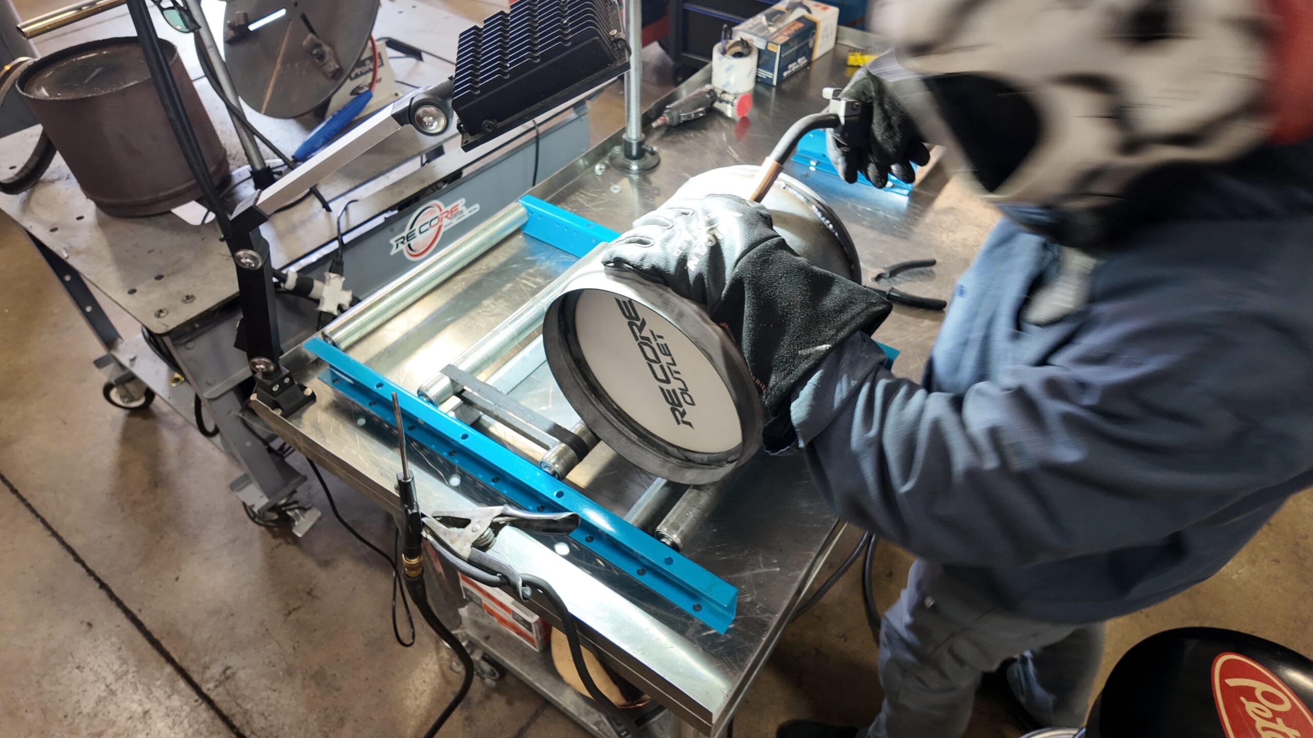 Technician cutting open a DPF housing with an angle grinder during recore service